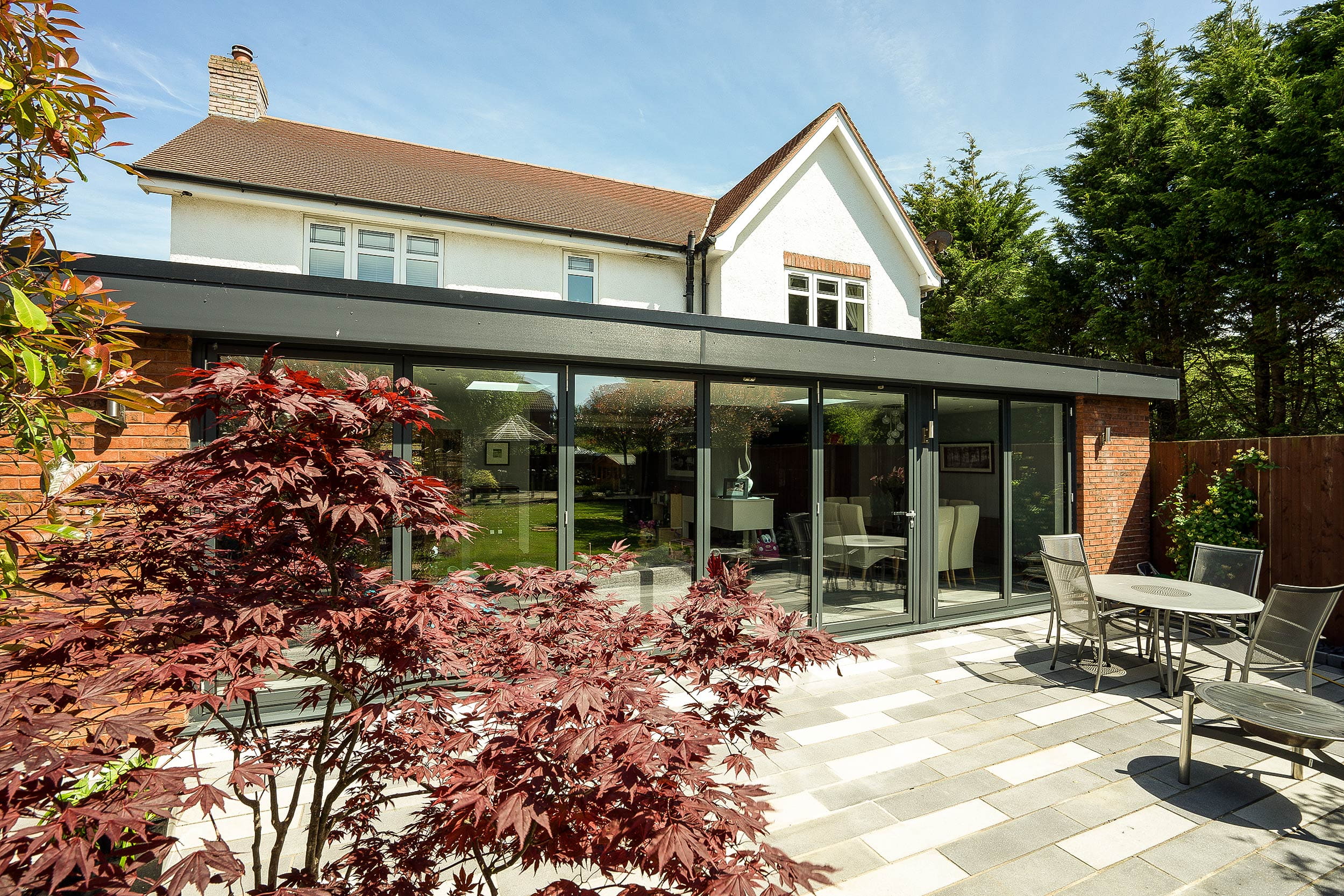 Large grey aluminium bifold doors with matching aluminium fascia boards supplied and fitted on the Wirral to complete this stunning open plan living space.