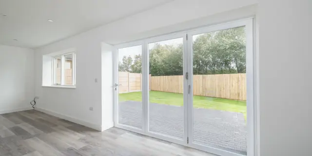 Looking out through bi-fold doors into the garden from kitchen/ diner