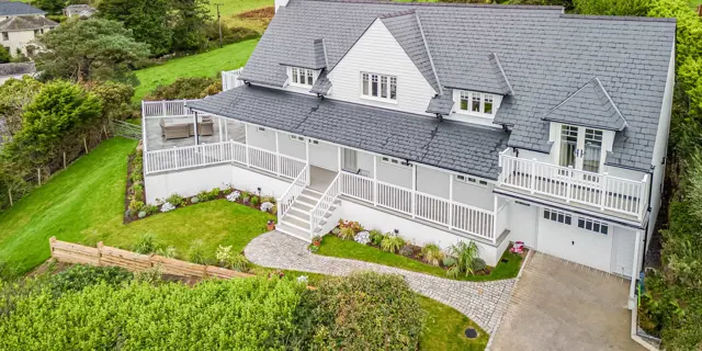 Drone shot of holiday home in Criccieth right side with driveway and garden