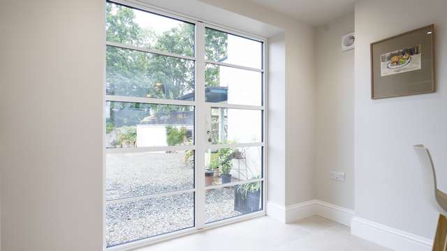 Internal view of the steel alternative aluminium doors in white with matching handle and horizontal glazing bars.