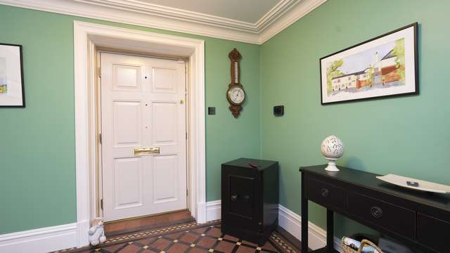 Internal view of this period home showing the white finish of the door internally with brass hardware and hinges.