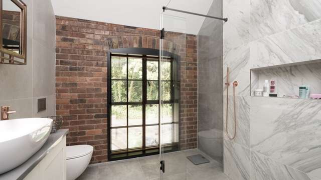 Bathroom fitted with large Crittall window.