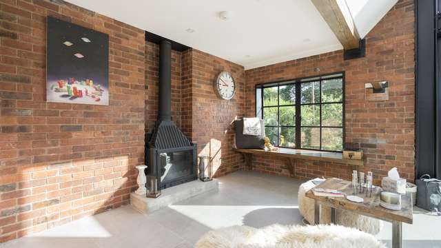 Another part of this large living area fitted with an authentic Crittall steel window.