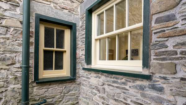 Showing the difference between the new and old, original timber sash window and larger new alu-clad sash window.