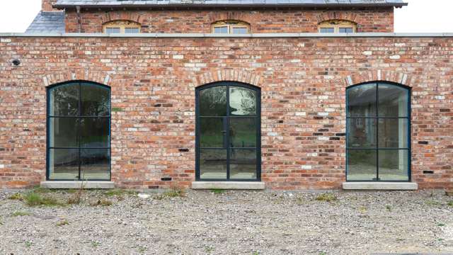 Three arched Crittall doors and windows.