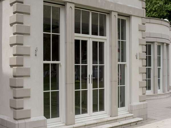 Close up detail shot of the Evolution timber french doors with top lights and Bygone sash windows to either side.