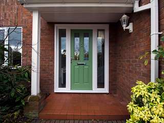 Main entrance door in green with chrome hardware, Lead lights, side lights and UPVC frame.