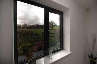 Internal view of aluminium window replacement in grey to match windows throughout the extension.