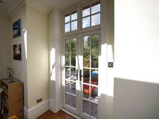 Internal view of Evolution timber alternative UPVC French doors with top lights and cast iron black door furniture.