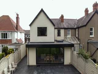 External shot of open plan extension with roof light and sliding door.
