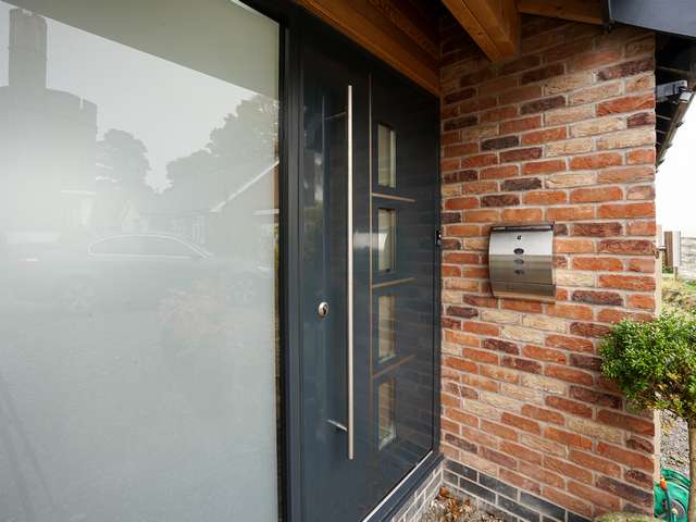 CLose up of aluminium entrance door and sidelight.