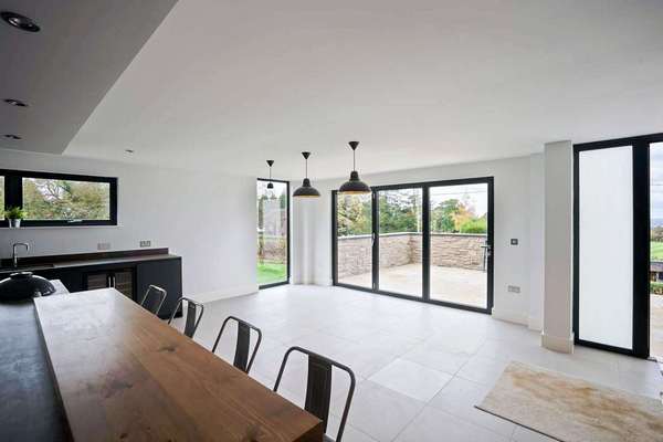 Open plan living space complete with aluminium bifold doors to create flow between the indoor and outdoor space.
