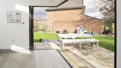 Internal view of the fully open corner-less bifolding doors looking out onto the garden.