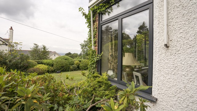Corner angle of the aluminium side windows showing views over the Dee Estuary.