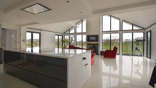 Open plan living area with grey aluminium windows.