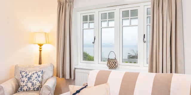 Large window with 2 sofas and a lamp 
