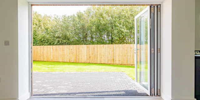 Looking out onto garden through fully open bi-fold doors
