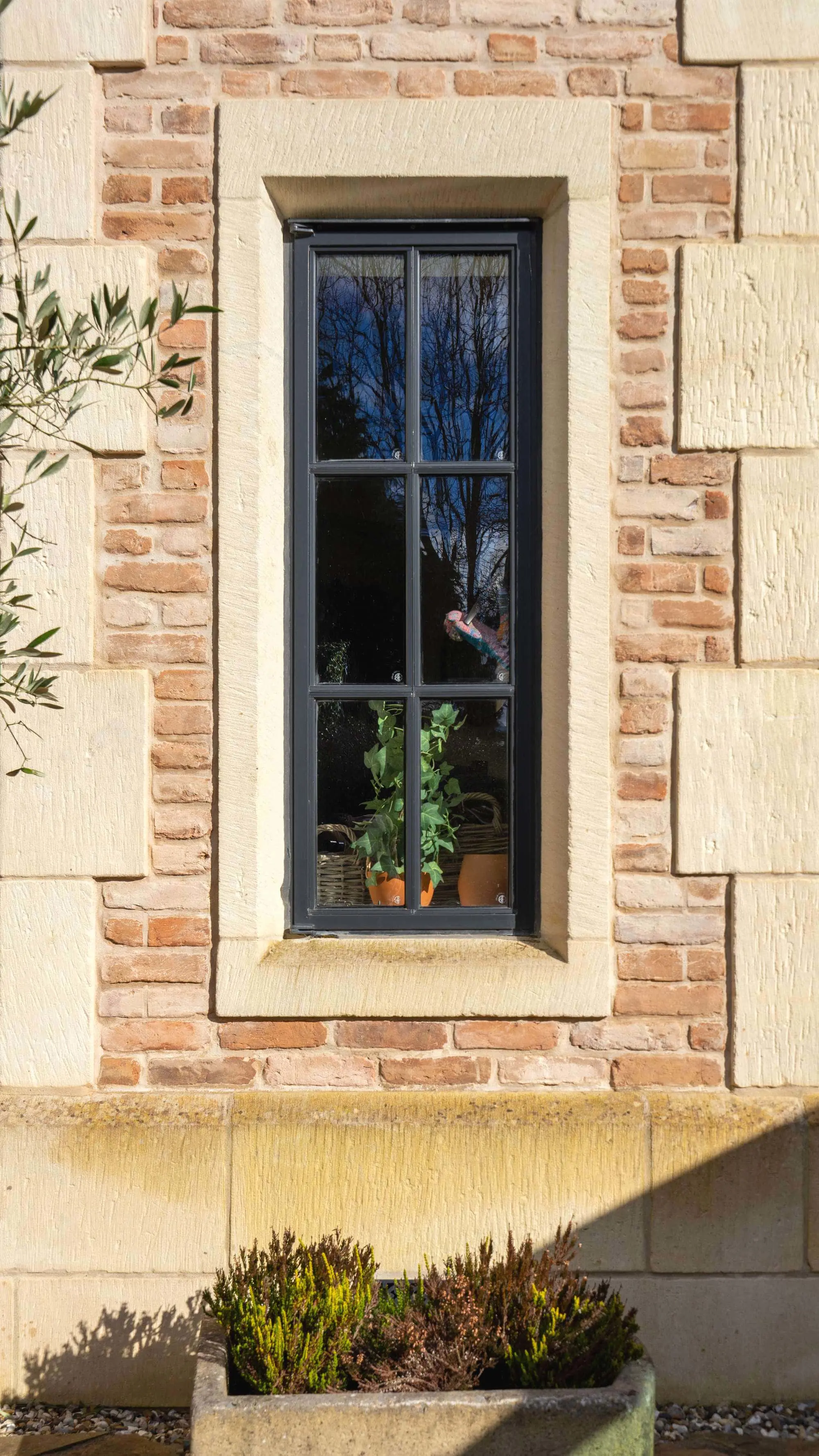 Slim Crittall steel window with external hinges.