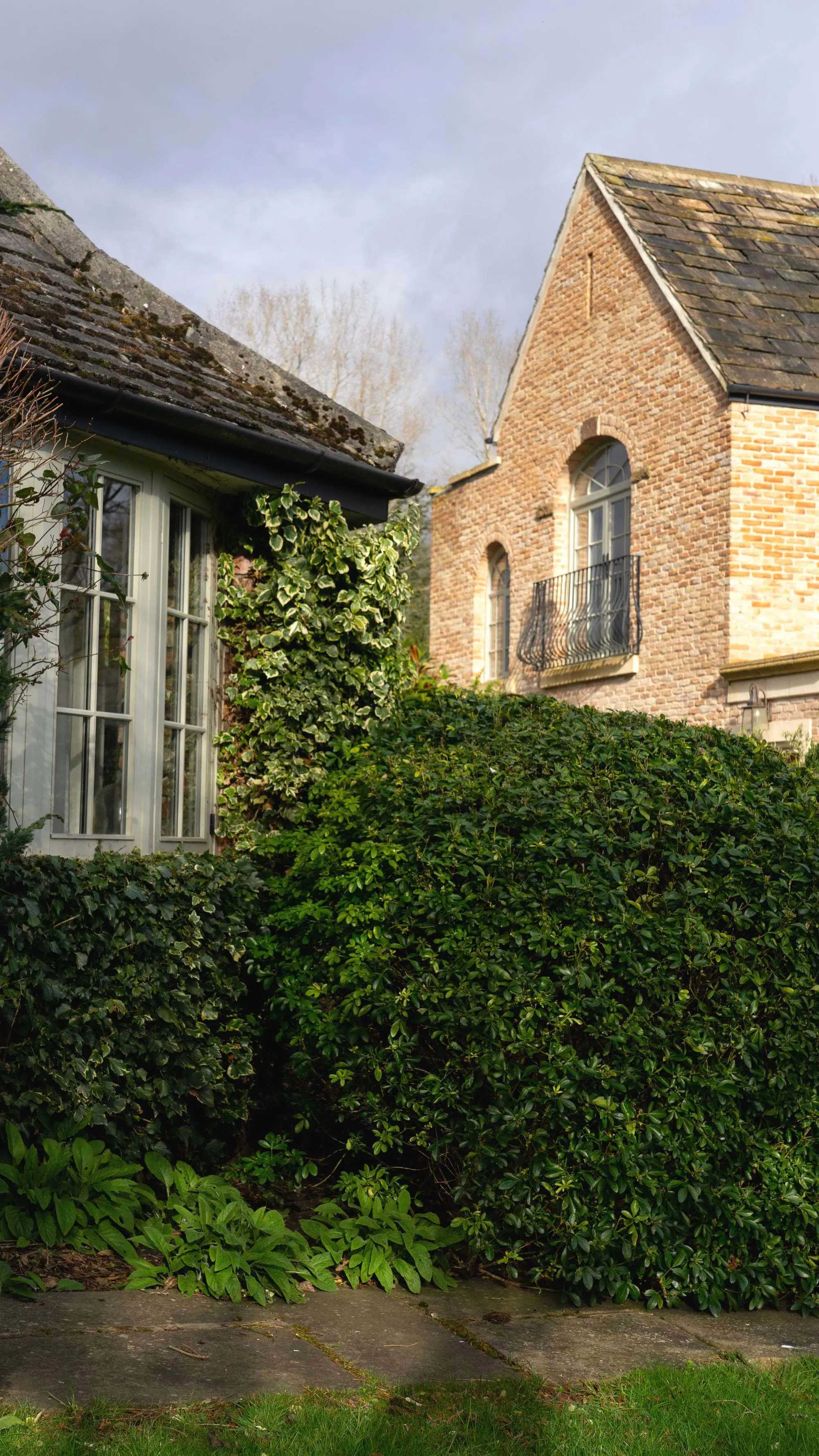 Abstract view of the agate grey arched timber windows.