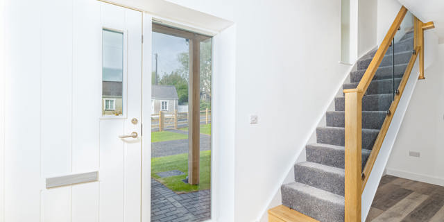 From the hallway looking out to front through big window next to the front door