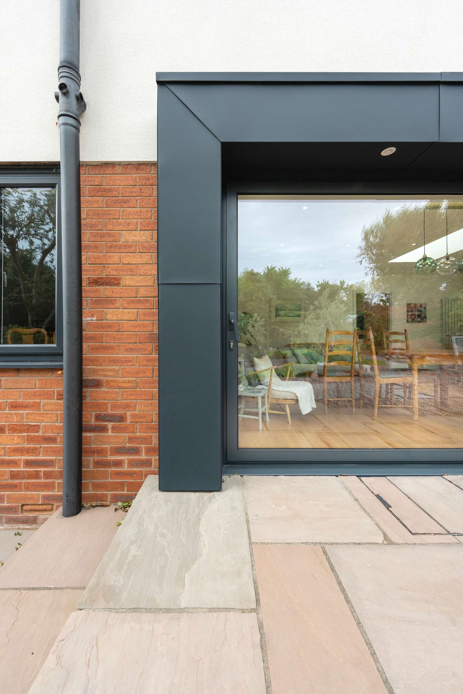 Aluminium sliding doors with feature zinc cladding.