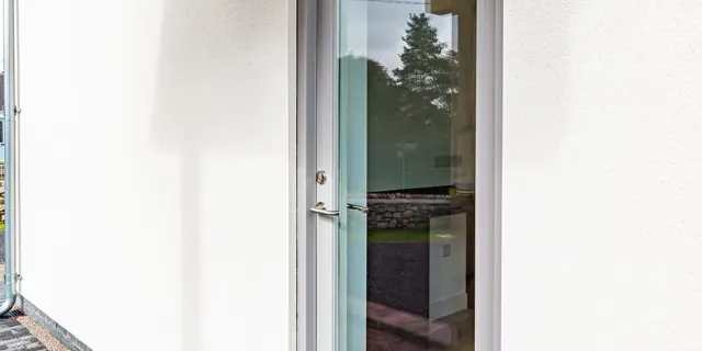 Grey side door to the property 
