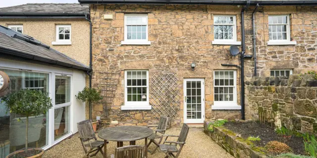 External view of timber window and door installation in period stone property.