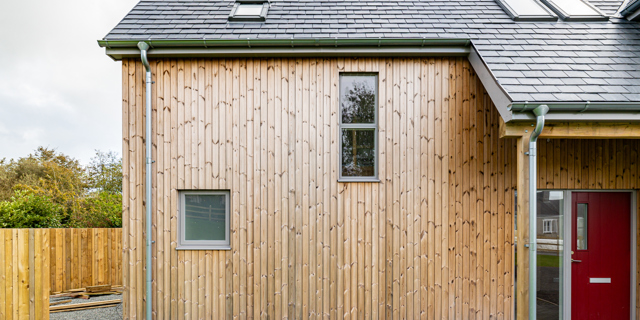 Wood cladding on property with 2 small windows