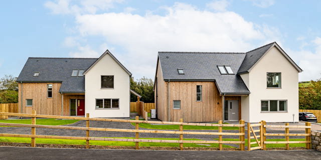 2 new build properties with wooden fence in front