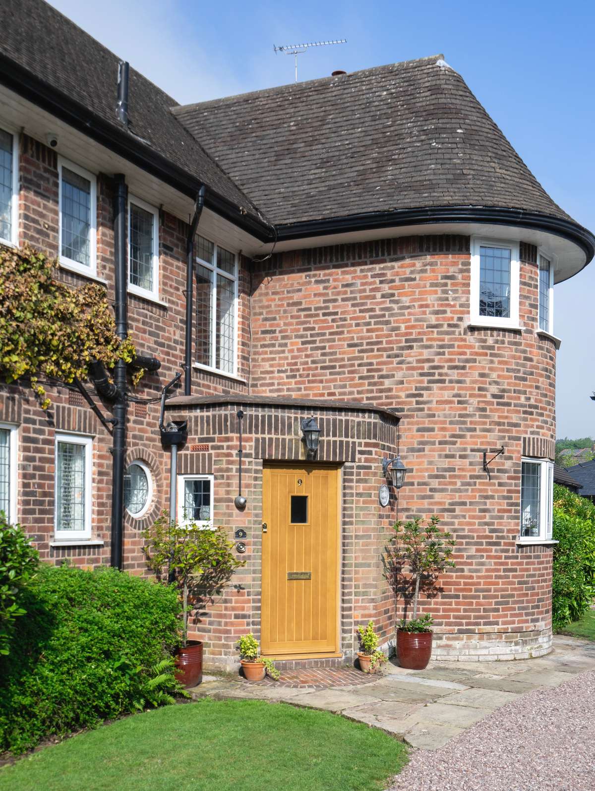 Oak entrance door in brick house.