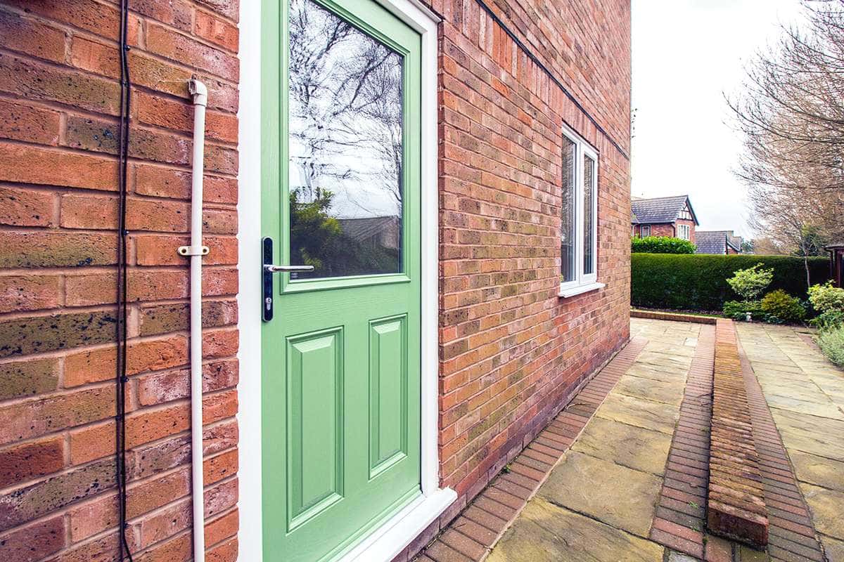 Side door detail in matching green to the front entrance door.