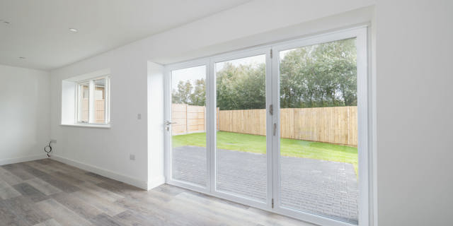 Looking out through bi-fold doors into the garden from kitchen/ diner