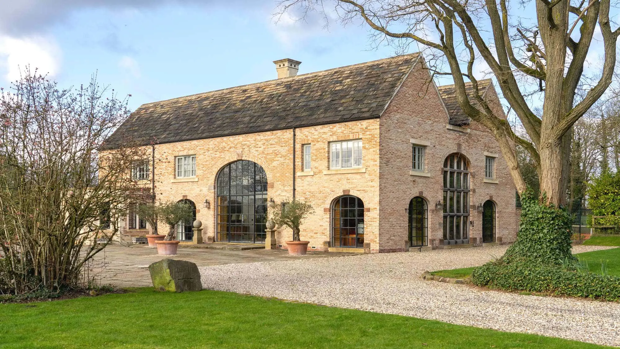 Angled view of the large French Farmhouse new build in Cheshire.