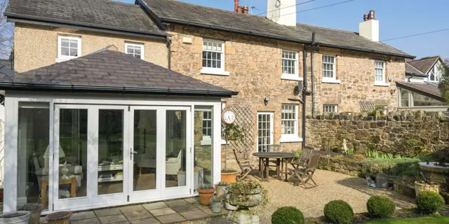 Wide view of stone property with installation of timber sash windows, Cheshire.