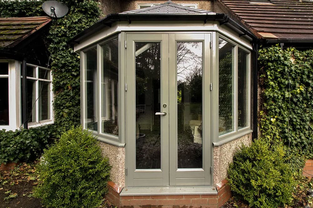 Alu-clad Conservatory with tiled and insulated roof.