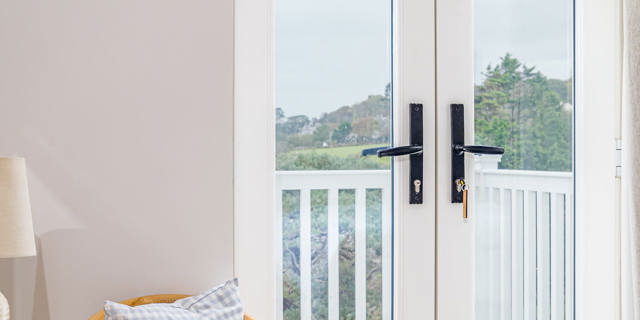 Sitting are in bedroom with french doors closed