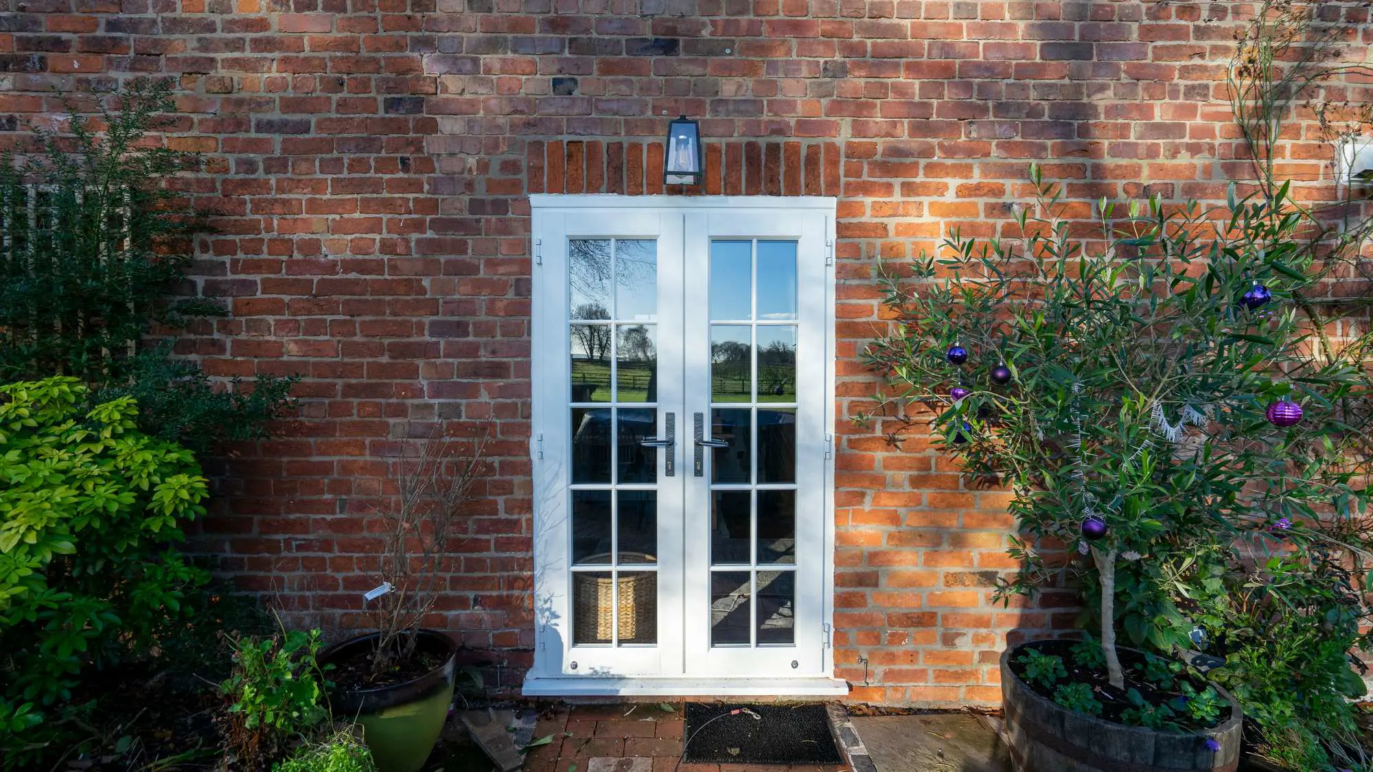 Evolution French doors in white with cast iron style handles.