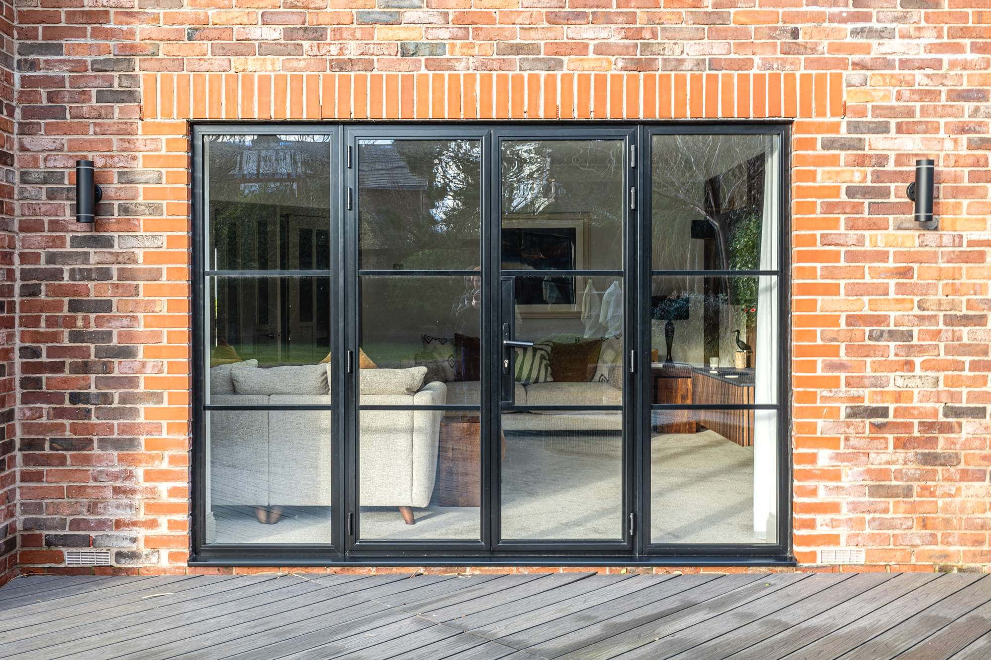 Black industrial style aluminium doors with sidelights.