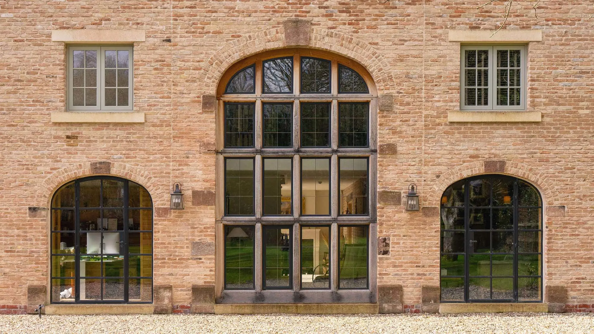 The front of the property featuring a beautifully symmetrical window and door installation.