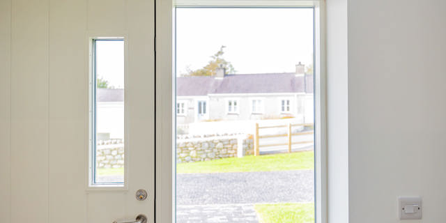 Cropped photo of door frame and window to front garden