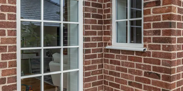 Outside view of vertical floor to ceiling window and small window to side