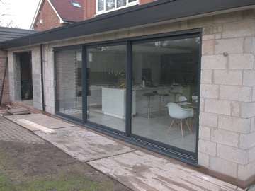 Triple glazed sliding doors installed in Bebington, Wirral. Product supplied by Sliders in powder coated aluminium.