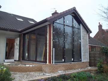 Aluminium Curtian walling glazed with self Clean glass, triple track Patio doors OXX .