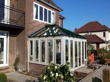 Caldy wirral. Installtion of Evoltion Storm windows and doors . double glazed . Argon gas filled . Bespokely painted . K2 Aluminium Traditional roof system