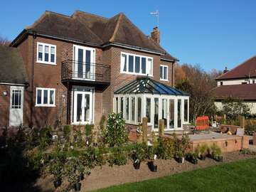 Caldy wirral. Installation and build . Windows and door in a white wood finsih. Conservatory Bespokly painted including roof . Glazed with Celcius Elite U value .9