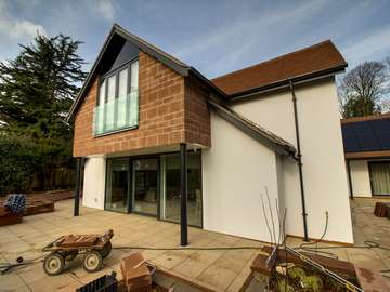 Feature balustrade with french doors and large sliding door on the ground level to break down the barrier between the indoor and outdoor living areas.