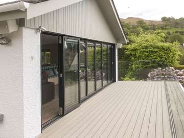 Making the most of the view yeah round with these stunning biffold doors adding the ultimate wow factor to this indoor outdoor living space.