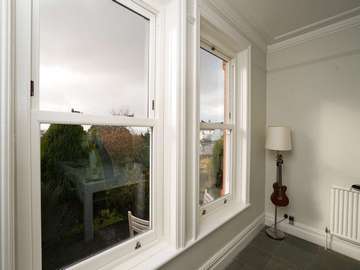 Dual Bygone UPVC sliding sash windows fitted with bronze hardware and double glazed panels in Heswall, Wirral.