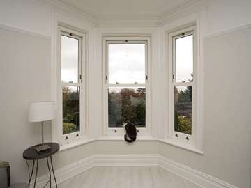 Feature bay window fitted with UPVC Bygone sash windows.