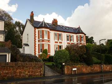 Installation of sliding sash windows in UPVC with white woodgrain finish for a authentic look.